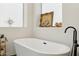 Serene bathroom showcasing a freestanding tub, elegant fixtures, and a decorative shelf at 1285 E Horseshoe Ave, Gilbert, AZ 85296