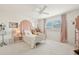 A cute bedroom featuring neutral walls and furniture, natural light, and pink accents at 1285 E Horseshoe Ave, Gilbert, AZ 85296