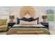 Neutral bedroom is decorated with a wall fan and filled with natural light from the two surrounding windows at 1285 E Horseshoe Ave, Gilbert, AZ 85296