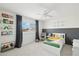 A cozy bedroom featuring a grey accent wall, book shelves, and comfortable rocking chair at 1285 E Horseshoe Ave, Gilbert, AZ 85296