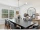 An elegant dining room featuring modern light fixture and sleek black table at 1285 E Horseshoe Ave, Gilbert, AZ 85296