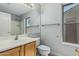 Well-lit bathroom with sink, toilet, large mirror, and window at 1343 W San Carlos Pl, Chandler, AZ 85248