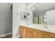 Well-lit bathroom with double sinks, framed mirrors, and wood cabinets, offering ample space at 1343 W San Carlos Pl, Chandler, AZ 85248