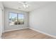 Bright bedroom with a street view from the window and wood flooring with a ceiling fan at 1343 W San Carlos Pl, Chandler, AZ 85248