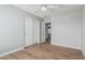 Cozy bedroom with laminate floors, natural lighting and closet with sliding doors for storage at 1343 W San Carlos Pl, Chandler, AZ 85248