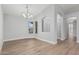 Formal dining area with a chandelier, arched doorway, and light wood-look flooring at 1343 W San Carlos Pl, Chandler, AZ 85248