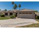 Inviting single-story home with a wide driveway and lush landscaping at 1343 W San Carlos Pl, Chandler, AZ 85248