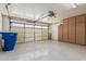 Clean garage with epoxy flooring, storage cabinets, and overhead door at 1343 W San Carlos Pl, Chandler, AZ 85248