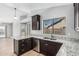 Modern kitchen features granite countertops, stainless steel appliances, and ample cabinet space at 1343 W San Carlos Pl, Chandler, AZ 85248