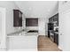 Updated kitchen featuring granite countertops, stainless steel appliances, and dark wood cabinets at 1343 W San Carlos Pl, Chandler, AZ 85248