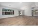 Spacious living room with wood-look floors, abundant natural light, and a sliding glass door at 1343 W San Carlos Pl, Chandler, AZ 85248