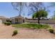 Backyard featuring well-manicured lawn, desert landscaping, covered patio, and mature trees at 14239 N Edgeworth Dr # A, Fountain Hills, AZ 85268
