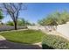Spacious backyard with lush green lawn, desert landscaping, and privacy wall, creating a serene outdoor oasis at 14239 N Edgeworth Dr # A, Fountain Hills, AZ 85268