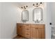Bathroom featuring a double sink vanity with wood cabinets, quartz countertops, and modern fixtures at 14239 N Edgeworth Dr # A, Fountain Hills, AZ 85268