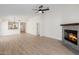 Open-concept living room with a fireplace, neutral decor, and hardwood floors at 14239 N Edgeworth Dr # A, Fountain Hills, AZ 85268