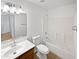Bright bathroom featuring a single vanity, a mirror, a toilet, and a bathtub-shower combo at 15162 W Monroe St, Goodyear, AZ 85338