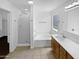 Bright bathroom featuring dual vanities, a separate shower, and a soaking tub at 15162 W Monroe St, Goodyear, AZ 85338