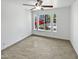 Bright bedroom with tile floors, ceiling fan, and multi-pane windows offering a view to the outside at 15162 W Monroe St, Goodyear, AZ 85338