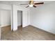 Bedroom with tile flooring, a ceiling fan, and closet with sliding doors at 15162 W Monroe St, Goodyear, AZ 85338