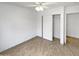 Vacant bedroom with neutral paint, tile flooring, ceiling fan and a closet with sliding doors at 15162 W Monroe St, Goodyear, AZ 85338