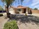 Attractive single-story home showcasing a well-manicured front yard with desert landscaping at 15162 W Monroe St, Goodyear, AZ 85338