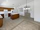 Spacious open-concept kitchen with an island, wood cabinets, and tile flooring extending into the adjacent living areas at 15162 W Monroe St, Goodyear, AZ 85338
