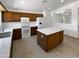 Spacious kitchen with dark wood cabinets, white countertops, and a central island at 15162 W Monroe St, Goodyear, AZ 85338
