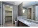 Well-lit bathroom with gray countertops, vanity mirror, and walk-in shower at 15215 N Kierland Blvd # 636, Scottsdale, AZ 85254