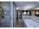 Spacious bathroom with dual vanities, a soaking tub, and separate glass-enclosed shower at 15215 N Kierland Blvd # 636, Scottsdale, AZ 85254