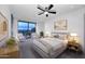 Inviting bedroom with a ceiling fan, sitting area, and cityscape views from the window at 15215 N Kierland Blvd # 636, Scottsdale, AZ 85254