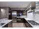 Stylish kitchen featuring granite countertops, stainless steel appliances, and dark cabinetry at 15215 N Kierland Blvd # 636, Scottsdale, AZ 85254