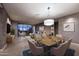 Open-concept living room and dining area featuring sleek modern design and large glass doors to a balcony at 15215 N Kierland Blvd # 636, Scottsdale, AZ 85254