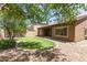 Picturesque backyard featuring a well-kept lawn, mature trees, and privacy, ideal for relaxation at 15674 W Mackenzie Dr, Goodyear, AZ 85395
