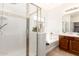 Bathroom with shower and separate tub, vanity with wood cabinets, and stylish tile details at 15674 W Mackenzie Dr, Goodyear, AZ 85395