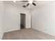 Carpeted bedroom with a ceiling fan and door leading to another room at 15674 W Mackenzie Dr, Goodyear, AZ 85395