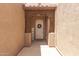 Inviting front entry with a white door, decorative wreath, and charming wood accents at 15674 W Mackenzie Dr, Goodyear, AZ 85395