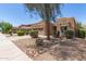 Charming single-story home featuring a well-manicured front yard and a two-car garage at 15674 W Mackenzie Dr, Goodyear, AZ 85395
