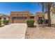 Charming single-story home featuring a well-manicured front yard and a two-car garage at 15674 W Mackenzie Dr, Goodyear, AZ 85395