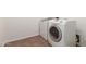 Laundry room with tile floors, washer, and dryer at 15674 W Mackenzie Dr, Goodyear, AZ 85395