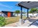 Spacious backyard featuring a well-maintained lawn, lush landscaping, a pergola, and a pool, perfect for relaxation and recreation at 1617 W Lamar Rd, Phoenix, AZ 85015