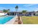 Picturesque backyard featuring a sparkling pool, a well-maintained lawn, and a cozy pergola-covered patio perfect for entertaining at 1617 W Lamar Rd, Phoenix, AZ 85015