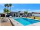 Stunning backyard showcasing a pristine pool, well-manicured lawn, and a charming pergola-covered patio for outdoor enjoyment at 1617 W Lamar Rd, Phoenix, AZ 85015