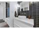 Elegant bathroom featuring a modern vanity, black tiled walls, and contemporary lighting at 1617 W Lamar Rd, Phoenix, AZ 85015