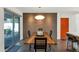 Elegant dining area featuring a modern table, brick wall, and adjacent to the kitchen at 1617 W Lamar Rd, Phoenix, AZ 85015