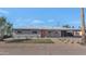 Charming single-story home with brickwork, desert landscaping, and a vibrant orange door at 1617 W Lamar Rd, Phoenix, AZ 85015