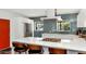 Elegant kitchen with white cabinets, an island cooktop, and sleek stainless-steel appliances at 1617 W Lamar Rd, Phoenix, AZ 85015