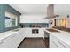 Chic kitchen featuring white cabinetry, island with bar seating, and stainless steel appliances at 1617 W Lamar Rd, Phoenix, AZ 85015