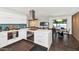 Open-concept kitchen featuring white cabinets, island seating, and seamless flow into dining area at 1617 W Lamar Rd, Phoenix, AZ 85015