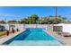 Stunning pool with a decorative wall and lush landscaping creates a serene oasis for relaxation and outdoor enjoyment at 1617 W Lamar Rd, Phoenix, AZ 85015