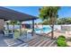 Beautiful backyard with a refreshing pool, a pergola, outdoor seating, and lush landscaping for relaxation and entertainment at 1617 W Lamar Rd, Phoenix, AZ 85015
